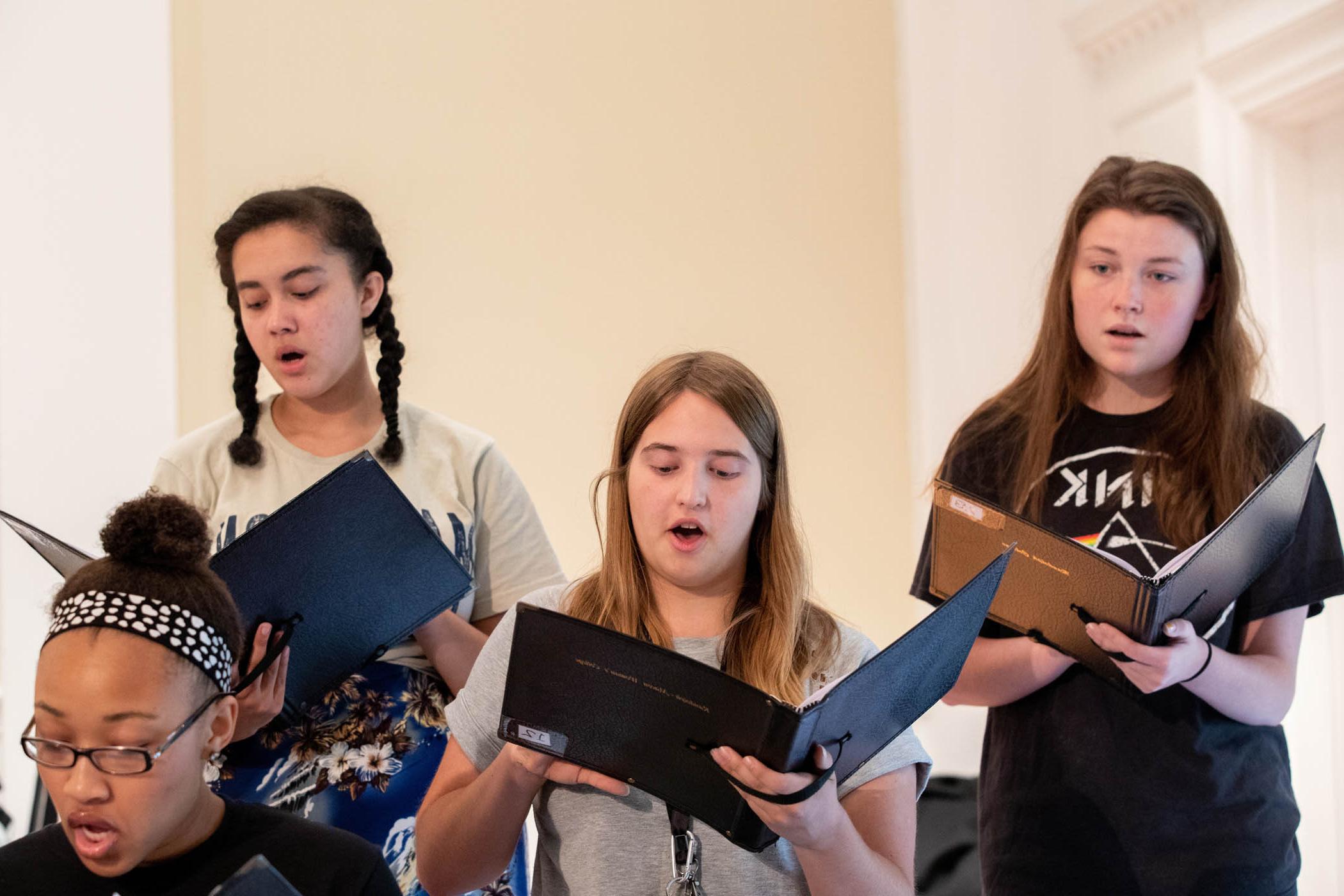 Female singers in chorale rehearsal